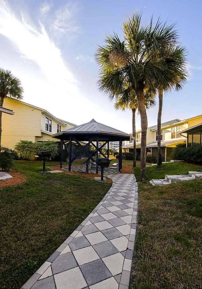 Gazebo with gas grills on a path through the lawn