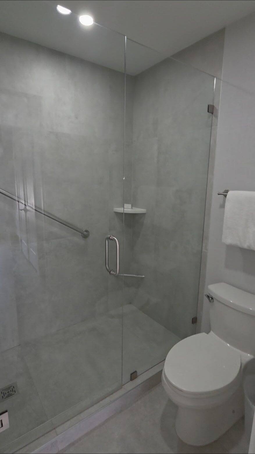 Glass-enclosed shower in an upstairs Deluxe Townhouse bathroom