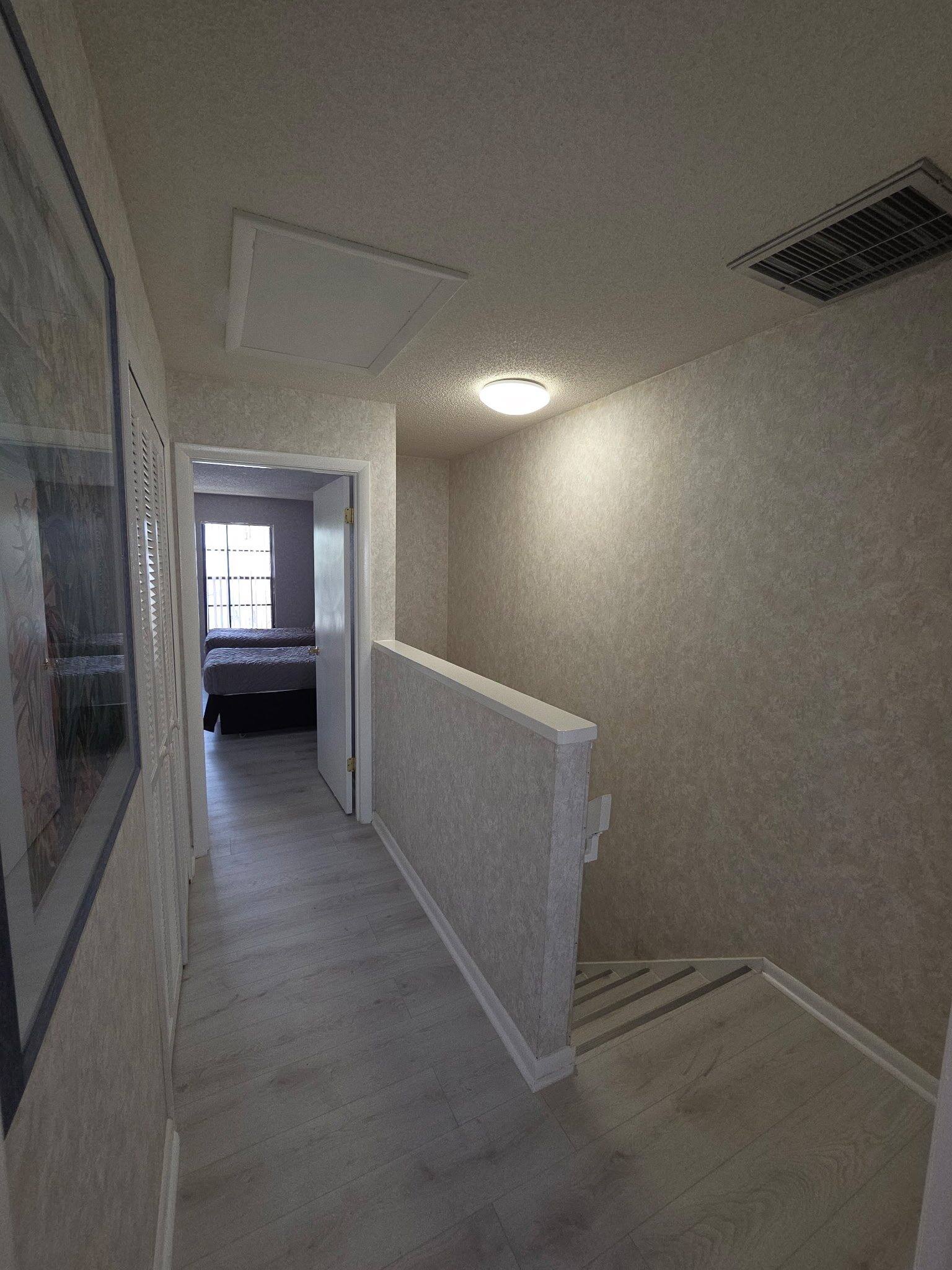 Upstairs hallway in a Townhouse with new wood-look flooring